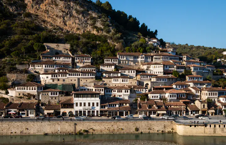 White Ottoman-era houses on the hillside above the Osum River in Berat, Albania